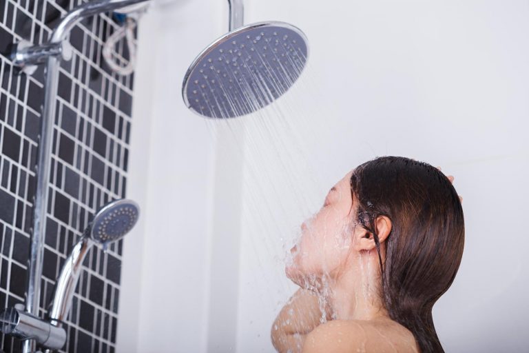woman-is-washing-her-face-by-cold-shower